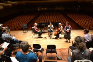 After several hours of coaching, the ensembles perform for one another on the stage of Davies Symphony Hall. 